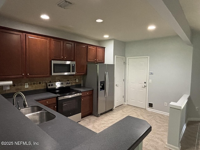 6967 Roundleaf Dr, Jacksonville, FL 32258 - kitchen featuring appliances with stainless steel finishes, backsplash, recessed lighting, dark countertops, and light tile patterned flooring