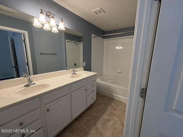 6967 Roundleaf Dr, Jacksonville, FL 32258 - full bath with double vanity, bathing tub / shower combination, a textured ceiling, and tile patterned floors