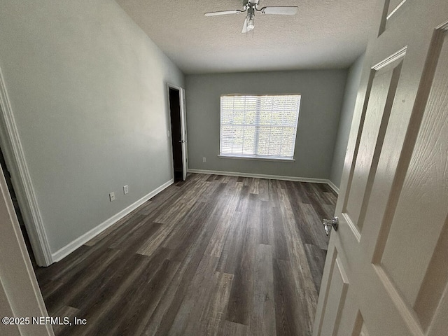 6967 Roundleaf Dr, Jacksonville, FL 32258 - empty room with a textured ceiling, dark wood-type flooring, and ceiling fan