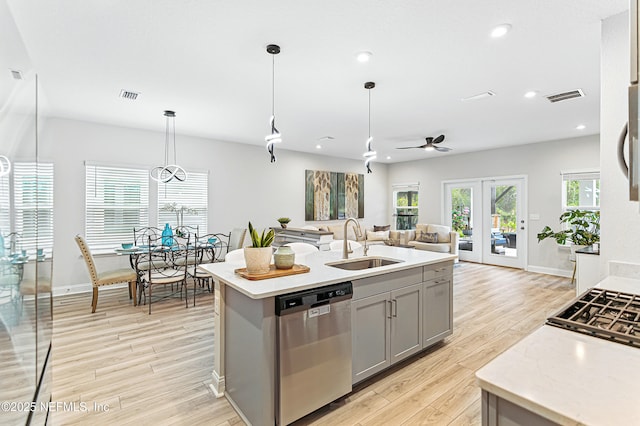 105 Meadow Creek Dr, Saint Johns, FL 32259 - kitchen featuring dishwasher, gray cabinets, light countertops, light wood-type flooring, and open floor plan