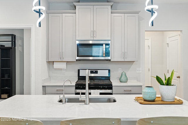 105 Meadow Creek Dr, Saint Johns, FL 32259 - kitchen with stainless steel appliances, light countertops, and pendant lighting
