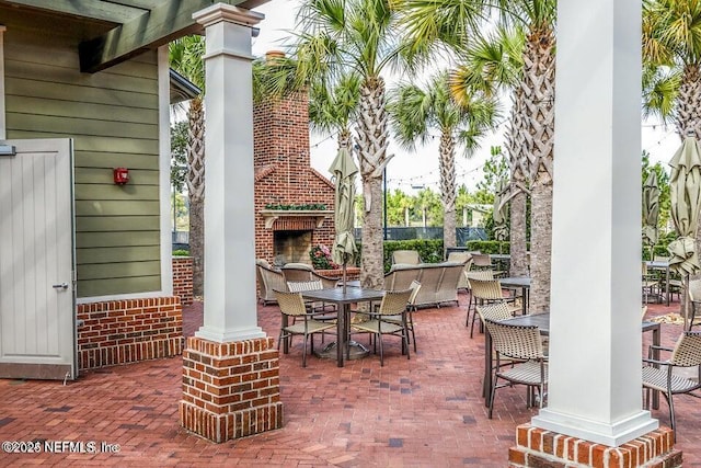 105 Meadow Creek Dr, Saint Johns, FL 32259 - view of patio / terrace featuring an outdoor brick fireplace and outdoor dining area