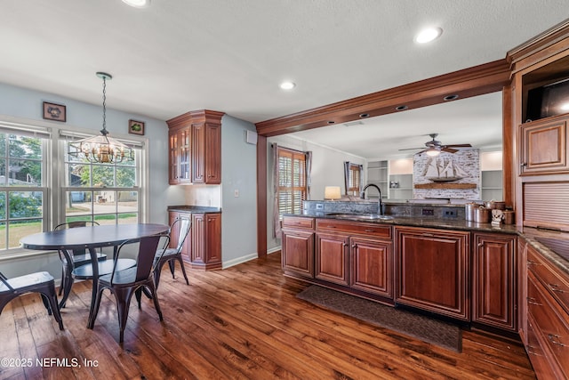 3679 Rustic Ln, Jacksonville, FL 32217 - kitchen with ceiling fan, dark wood-style floors, pendant lighting, glass insert cabinets, and recessed lighting