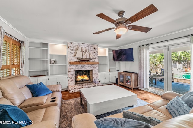 3679 Rustic Ln, Jacksonville, FL 32217 - living area with crown molding, wood finished floors, ceiling fan, a fireplace, and built in features