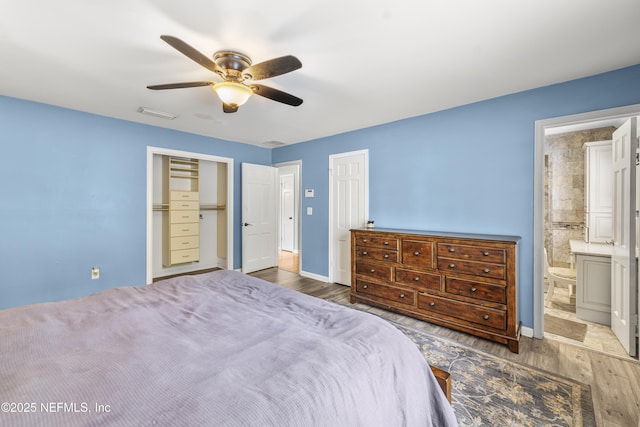 3679 Rustic Ln, Jacksonville, FL 32217 - bedroom with wood finished floors, ceiling fan, and ensuite bath