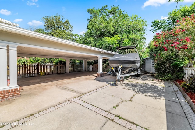 3679 Rustic Ln, Jacksonville, FL 32217 - view of patio featuring driveway and a carport