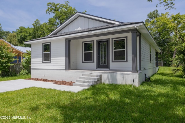 460 S Nassau St, Saint Augustine, FL 32084 - view of front of home featuring a porch, board and batten siding, and a front yard