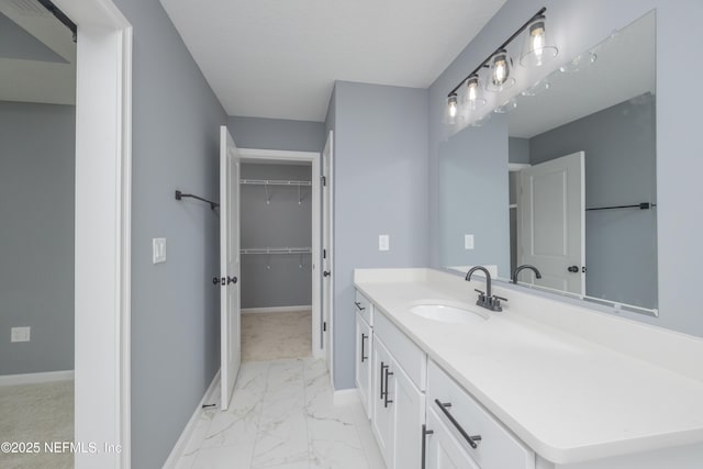 460 S Nassau St, Saint Augustine, FL 32084 - bathroom with marble finish floors, vanity, and a walk in closet