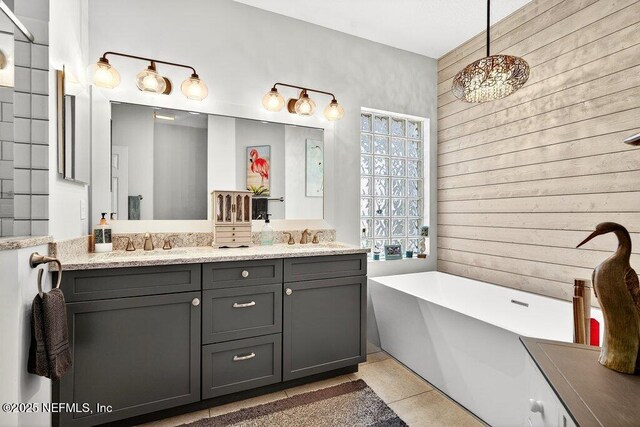 611 Selva Lakes Cir, Atlantic Beach, FL 32233 - full bathroom featuring double vanity, a freestanding bath, wooden walls, tile patterned flooring, and a chandelier