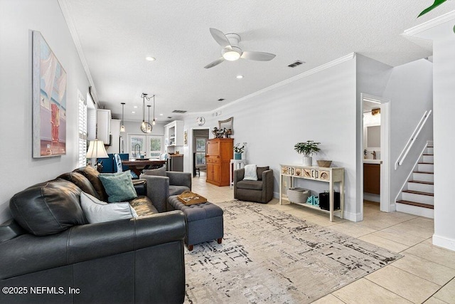 611 Selva Lakes Cir, Atlantic Beach, FL 32233 - living room with ceiling fan, ornamental molding, stairway, light tile patterned floors, and a textured ceiling