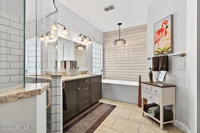 611 Selva Lakes Cir, Atlantic Beach, FL 32233 - bathroom featuring a bathtub, vanity, a textured ceiling, tile patterned flooring, and a chandelier