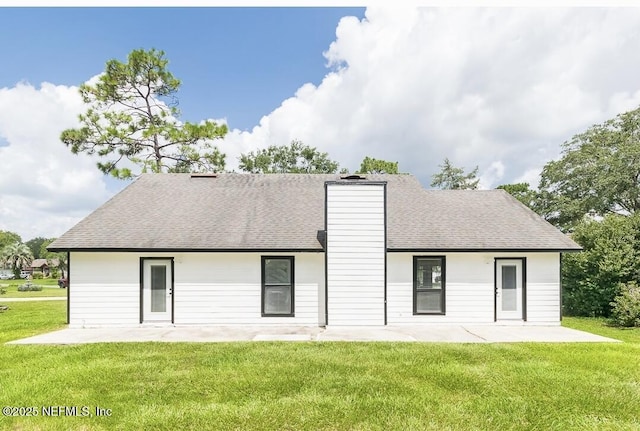 8820 Bandera Cir S, Jacksonville, FL 32244 - rear view of house featuring a patio, a lawn, and roof with shingles
