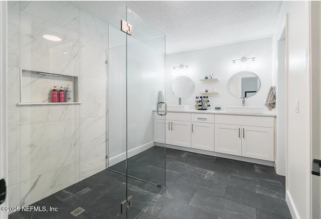 8820 Bandera Cir S, Jacksonville, FL 32244 - bathroom with marble finish flooring, double vanity, a textured ceiling, and a walk in shower