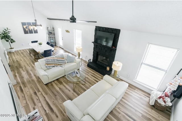 8820 Bandera Cir S, Jacksonville, FL 32244 - living area with a chandelier, ceiling fan, a fireplace, light wood-type flooring, and lofted ceiling