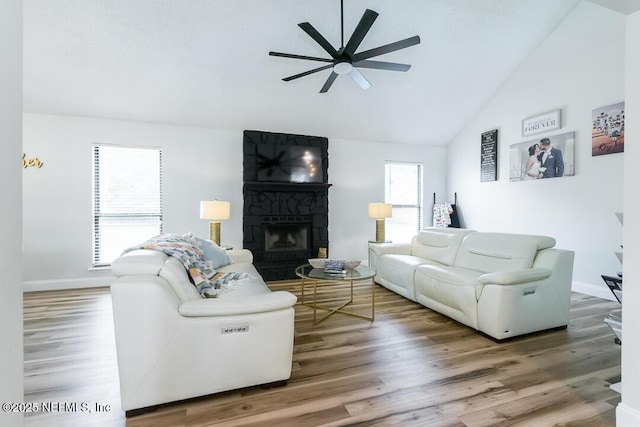 8820 Bandera Cir S, Jacksonville, FL 32244 - living room with a ceiling fan, a fireplace, wood finished floors, and high vaulted ceiling