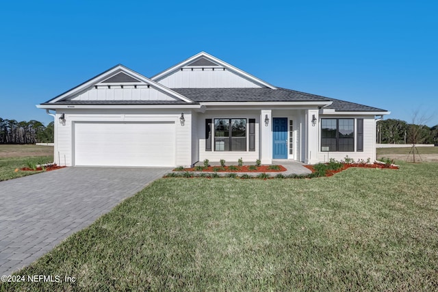 85448 Sandy Ridge Loop Unit 0049, Yulee, FL 32097 - modern farmhouse style home featuring an attached garage, decorative driveway, a front lawn, and board and batten siding
