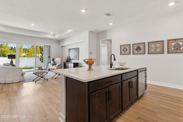 85448 Sandy Ridge Loop Unit 0049, Yulee, FL 32097 - kitchen featuring open floor plan, light wood finished floors, dark brown cabinets, light countertops, and dishwasher