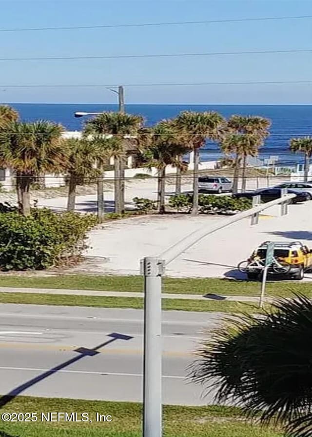3700 Atlantic Ave Unit 405, New Smyrna Beach, FL 32169 - view of asphalt street featuring a water view, street lighting, and sidewalks
