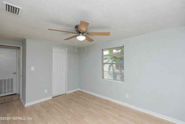 3303 Jones St, Jacksonville, FL 32206 - unfurnished room featuring light wood-style flooring, ceiling fan, and a textured ceiling