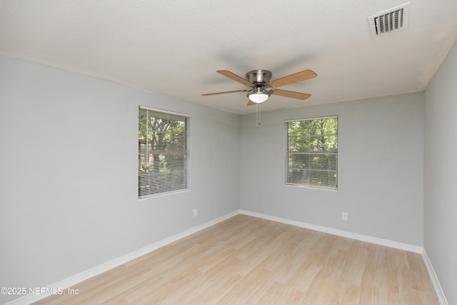 3303 Jones St, Jacksonville, FL 32206 - empty room featuring wood finished floors, plenty of natural light, and a ceiling fan