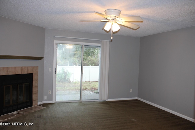 791 Assisi Ln Unit 302, Jacksonville, FL 32233 - unfurnished living room featuring ceiling fan, a textured ceiling, and a tile fireplace