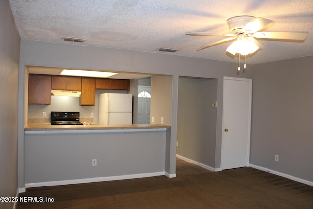 791 Assisi Ln Unit 302, Jacksonville, FL 32233 - kitchen with freestanding refrigerator, electric range, dark carpet, brown cabinets, and ceiling fan