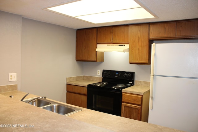 791 Assisi Ln Unit 302, Jacksonville, FL 32233 - kitchen with freestanding refrigerator, black range with electric stovetop, under cabinet range hood, and brown cabinets