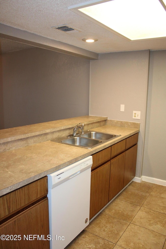 791 Assisi Ln Unit 302, Jacksonville, FL 32233 - kitchen featuring dishwasher, light countertops, brown cabinetry, light tile patterned flooring, and recessed lighting