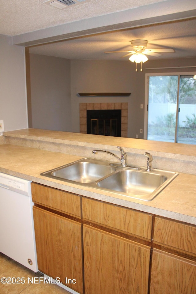 791 Assisi Ln Unit 302, Jacksonville, FL 32233 - kitchen with dishwasher, light countertops, a fireplace, and tile patterned floors