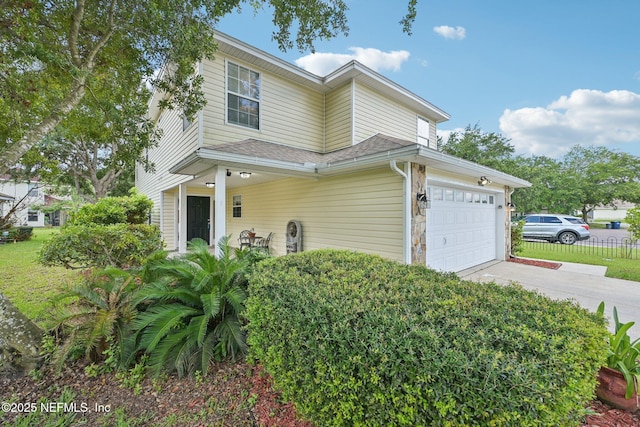 96016 Gray Heron Ct, Yulee, FL 32097 - traditional-style house with driveway, an attached garage, and roof with shingles