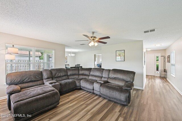 96016 Gray Heron Ct, Yulee, FL 32097 - living room featuring wood finished floors, a textured ceiling, a ceiling fan, and plenty of natural light