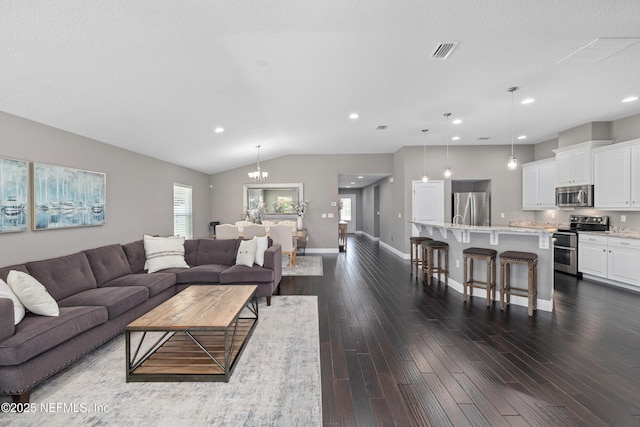 15067 Durbin Cove Way, Jacksonville, FL 32259 - living room with dark wood-style floors, lofted ceiling, recessed lighting, and a chandelier