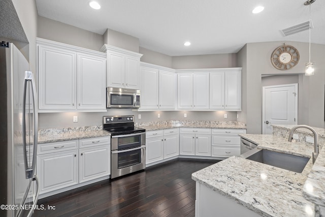 15067 Durbin Cove Way, Jacksonville, FL 32259 - kitchen featuring appliances with stainless steel finishes, dark wood-style floors, white cabinetry, recessed lighting, and light stone countertops