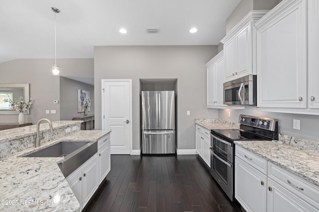 15067 Durbin Cove Way, Jacksonville, FL 32259 - kitchen featuring stainless steel appliances, white cabinetry, light stone countertops, lofted ceiling, and recessed lighting