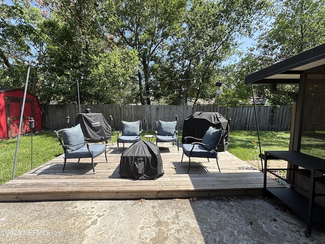 3112 Hampstead Dr, Jacksonville, FL 32225 - deck featuring a fenced backyard, a storage unit, and grilling area