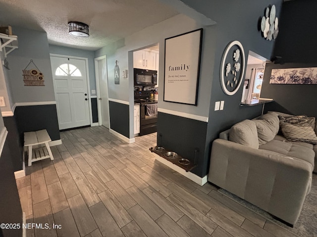 3112 Hampstead Dr, Jacksonville, FL 32225 - living room featuring wood finished floors and a textured ceiling