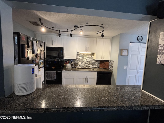 3112 Hampstead Dr, Jacksonville, FL 32225 - kitchen with black appliances, white cabinets, a peninsula, a textured ceiling, and tasteful backsplash