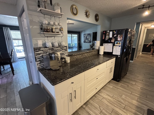 3112 Hampstead Dr, Jacksonville, FL 32225 - kitchen featuring freestanding refrigerator, a textured ceiling, open shelves, backsplash, and light wood-style flooring