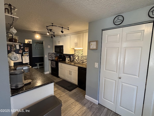 3112 Hampstead Dr, Jacksonville, FL 32225 - kitchen featuring black appliances, dark countertops, white cabinetry, tasteful backsplash, and wood finished floors