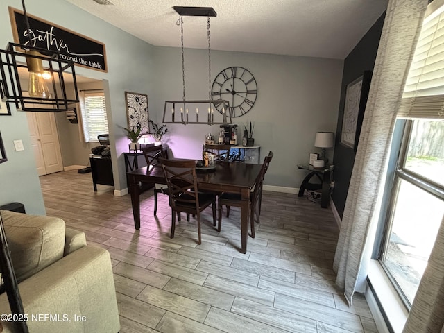 3112 Hampstead Dr, Jacksonville, FL 32225 - dining space featuring wood finished floors, a textured ceiling, and a chandelier
