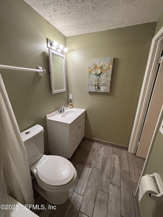 3112 Hampstead Dr, Jacksonville, FL 32225 - bathroom with a textured ceiling, wood tiled floors, and vanity