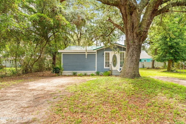 610 Division St, Fernandina Beach, FL 32034 - view of front of home with entry steps and a metal roof