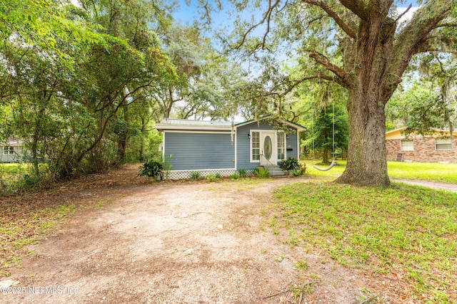 610 Division St, Fernandina Beach, FL 32034 - view of front of home with entry steps and a metal roof