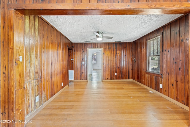 610 Division St, Fernandina Beach, FL 32034 - empty room featuring wood finished floors, wood walls, and ceiling fan