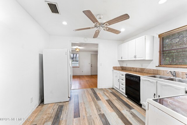 610 Division St, Fernandina Beach, FL 32034 - kitchen with white appliances, white cabinetry, recessed lighting, light wood finished floors, and ceiling fan