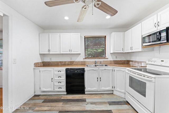 610 Division St, Fernandina Beach, FL 32034 - kitchen with black dishwasher, electric range, stainless steel microwave, white cabinets, and recessed lighting