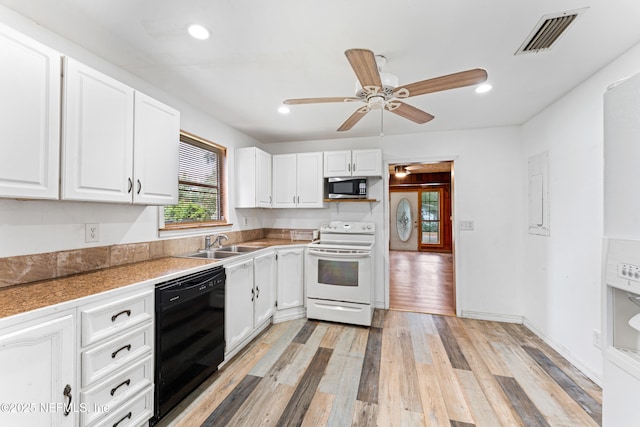 610 Division St, Fernandina Beach, FL 32034 - kitchen featuring electric stove, black dishwasher, stainless steel microwave, white cabinets, and light wood-style flooring