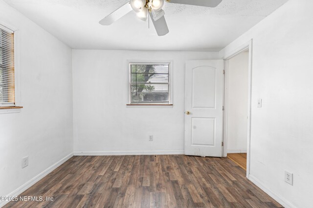 610 Division St, Fernandina Beach, FL 32034 - unfurnished bedroom with wood finished floors and a ceiling fan