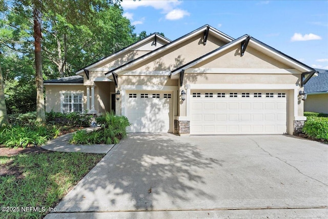 85339 Amagansett Dr, Fernandina Beach, FL 32034 - view of front of home featuring stucco siding, a garage, driveway, and stone siding
