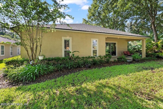85339 Amagansett Dr, Fernandina Beach, FL 32034 - view of front of house featuring a front lawn and stucco siding